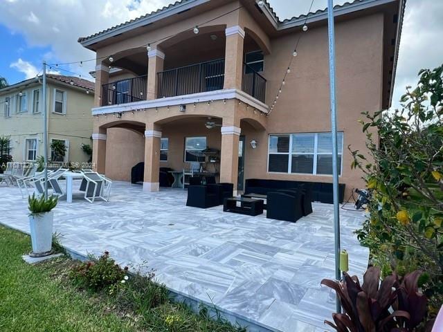 back of house with a balcony and a patio area