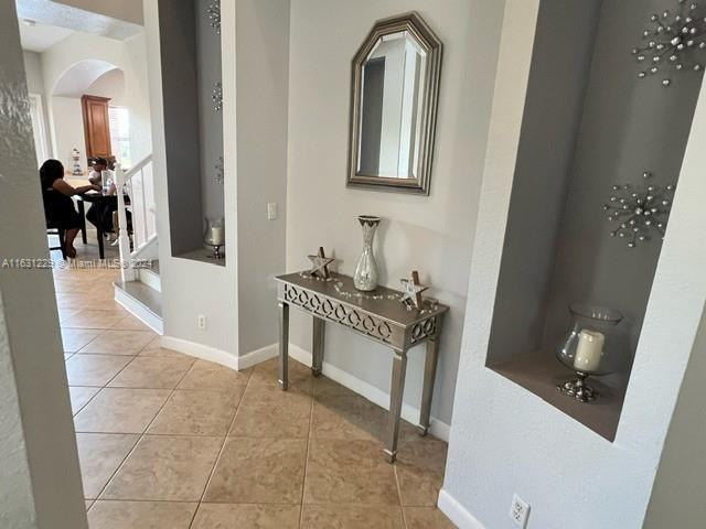 corridor with light tile patterned flooring