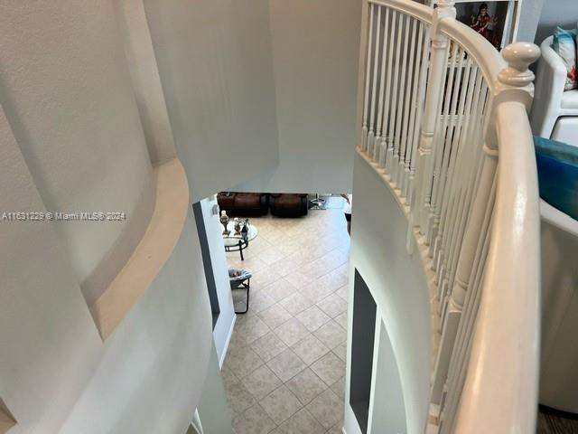 stairs featuring tile patterned floors