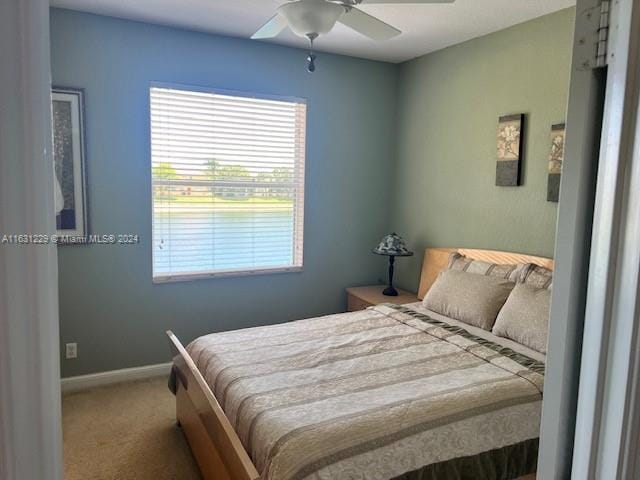 carpeted bedroom with ceiling fan