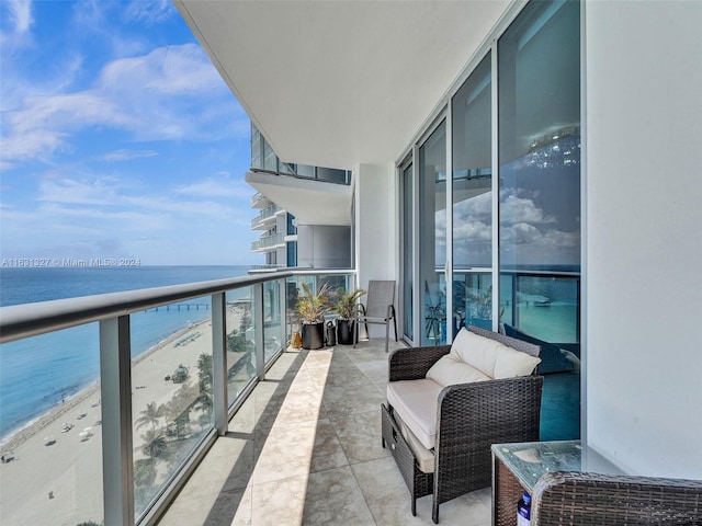 balcony with a water view and a beach view