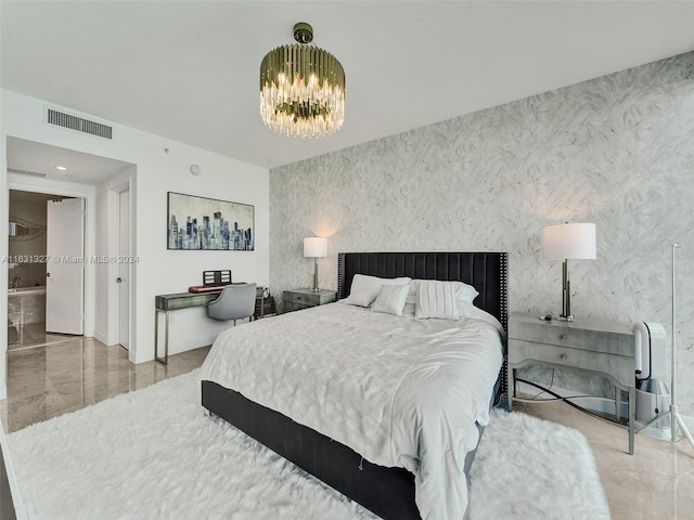 tiled bedroom featuring ensuite bath and a chandelier