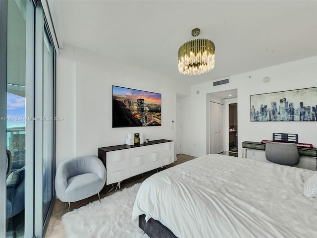 bedroom featuring a notable chandelier and access to outside