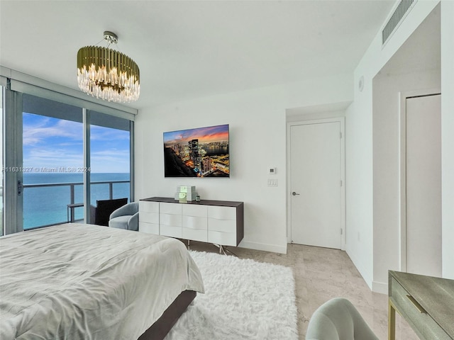 bedroom featuring a notable chandelier, access to exterior, and expansive windows