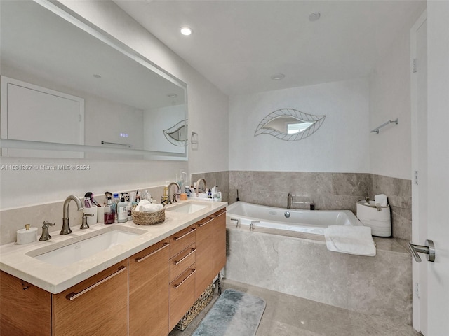 bathroom featuring tile patterned floors, double sink vanity, and tiled bath