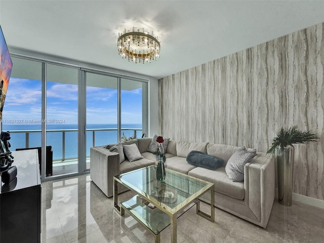 living room featuring a wall of windows, a water view, a notable chandelier, and light tile patterned floors