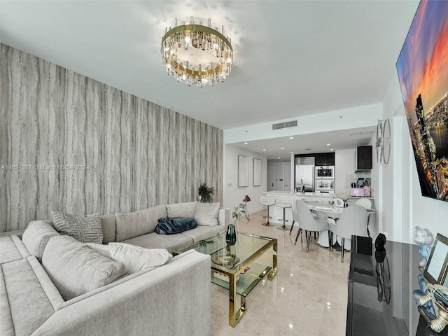 living room featuring a notable chandelier and sink