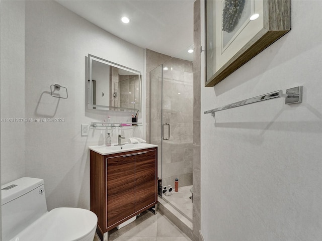 bathroom with vanity, toilet, a shower with door, and tile patterned flooring