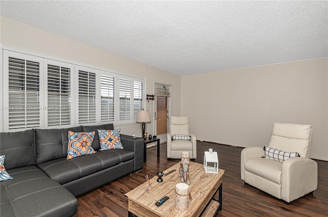 living room with dark hardwood / wood-style floors and a textured ceiling