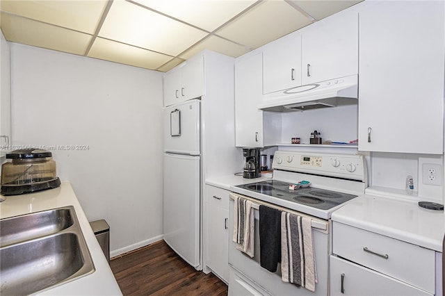 kitchen with a paneled ceiling, white appliances, white cabinets, sink, and dark hardwood / wood-style floors