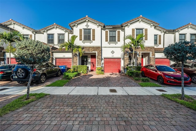 multi unit property featuring a garage