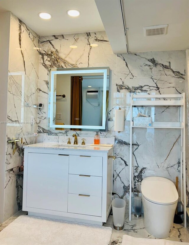 bathroom with tile patterned flooring, tile walls, toilet, and vanity