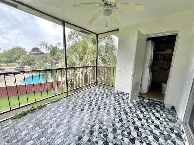 unfurnished sunroom with ceiling fan