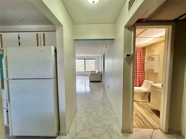 7480 NW 17th St Unit 305, Plantation, FL 33313 - corridor with a textured ceiling and light tile patterned floors