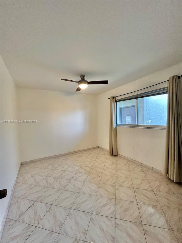 unfurnished room with ceiling fan