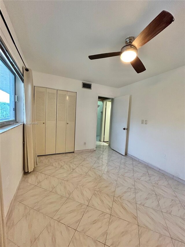 7480 NW 17th St Unit 305, Plantation, FL 33313 - unfurnished bedroom with a ceiling fan and a closet