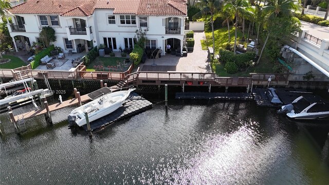 dock area featuring a patio area and a water view