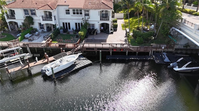 view of dock featuring a patio area and a water view