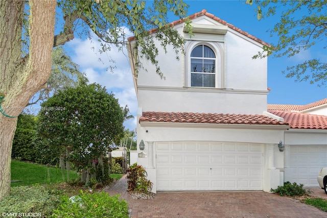 mediterranean / spanish-style home with a garage