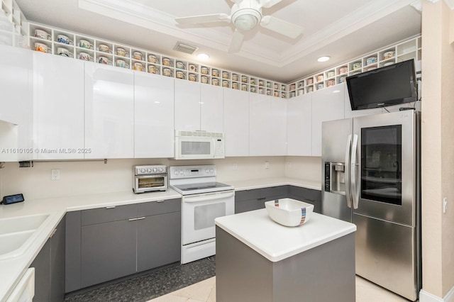 kitchen featuring sink, gray cabinets, a kitchen island, white appliances, and white cabinets