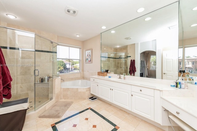 bathroom with vanity and independent shower and bath