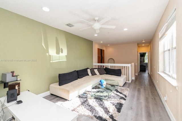 living room featuring light hardwood / wood-style floors and ceiling fan