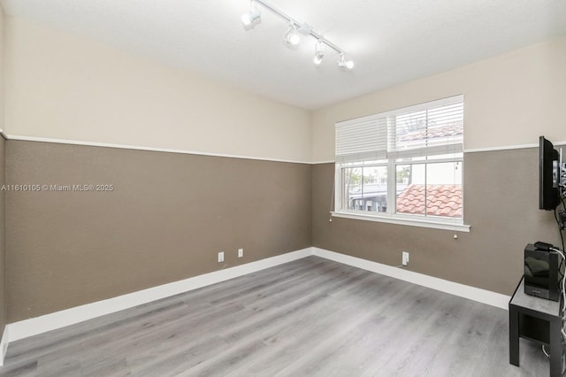 interior space featuring rail lighting and light wood-type flooring