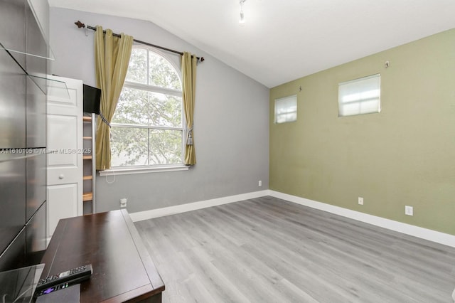 interior space with vaulted ceiling and light hardwood / wood-style floors