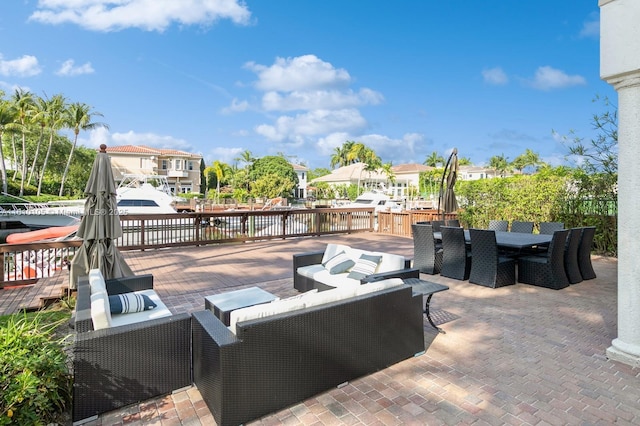 view of patio featuring a deck with water view and an outdoor living space