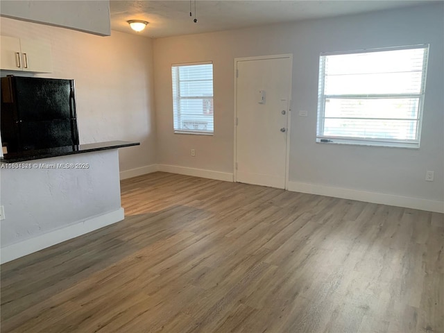 unfurnished living room featuring hardwood / wood-style floors