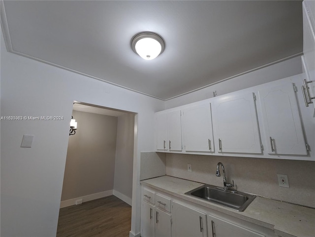 kitchen featuring white cabinets, dark wood-type flooring, and sink