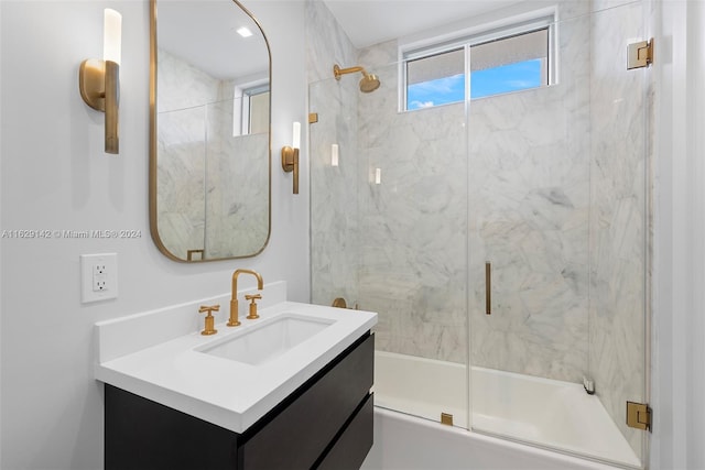 bathroom featuring enclosed tub / shower combo and vanity