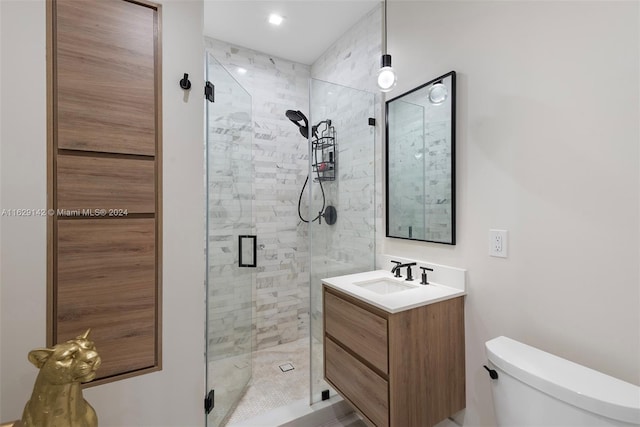 bathroom featuring walk in shower, vanity, and toilet