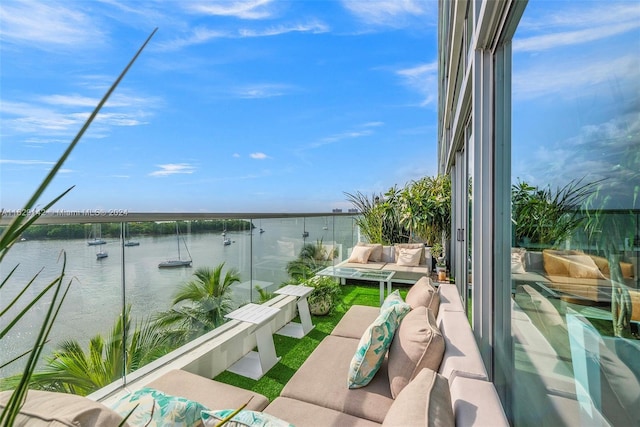 balcony with outdoor lounge area and a water view