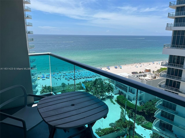 balcony with a water view and a beach view