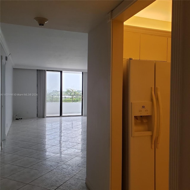 hall featuring floor to ceiling windows and light tile patterned flooring