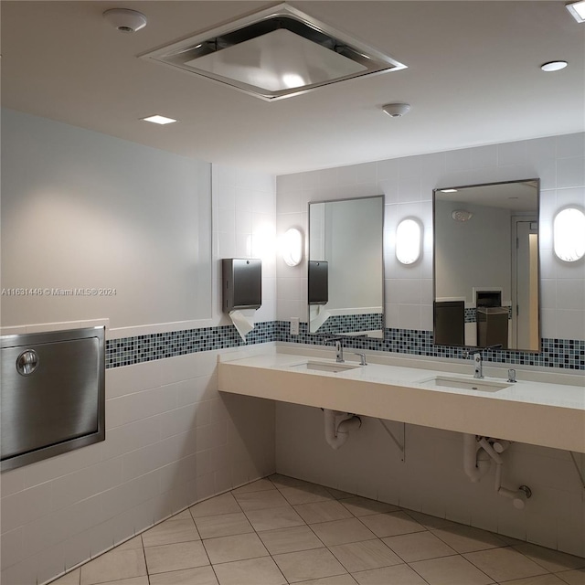 bathroom featuring tile patterned flooring and tile walls