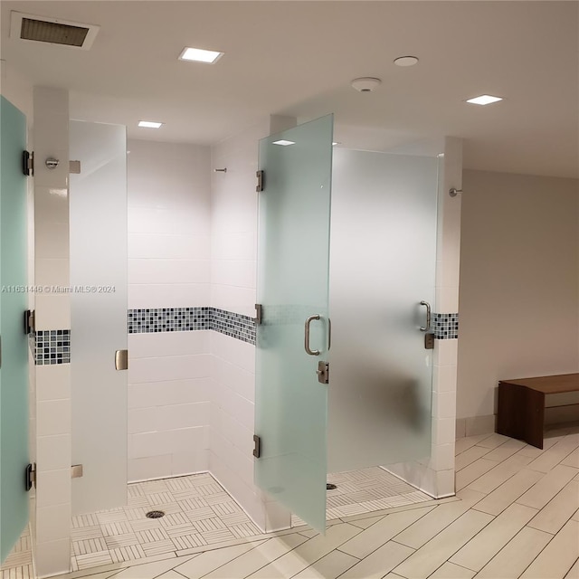 bathroom featuring a stall shower and visible vents