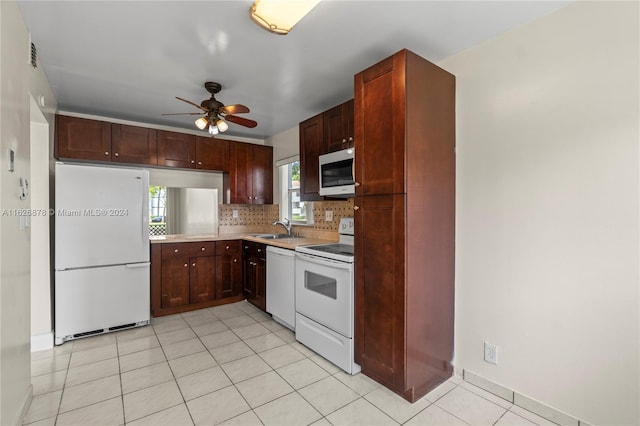 kitchen with light tile patterned flooring, white appliances, ceiling fan, decorative backsplash, and sink