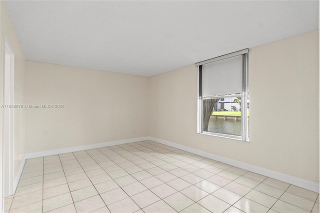 tiled empty room with a water view