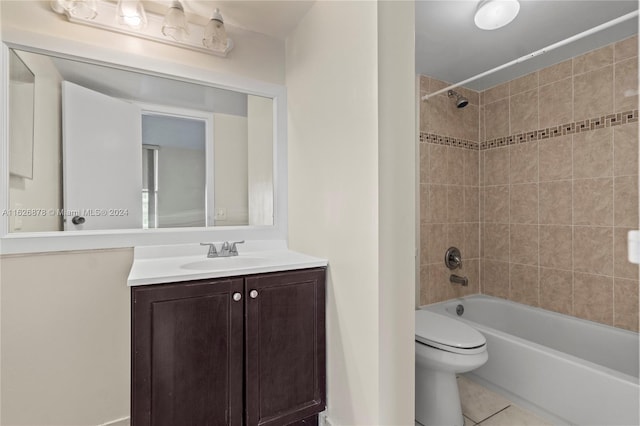 bathroom with toilet, tile patterned floors,  shower combination, and vanity