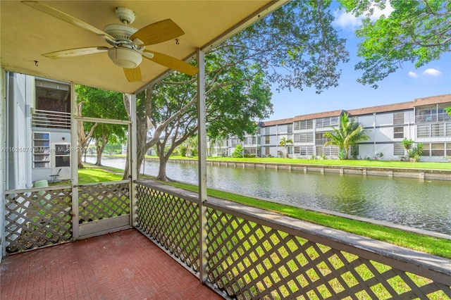 balcony with a ceiling fan and a water view