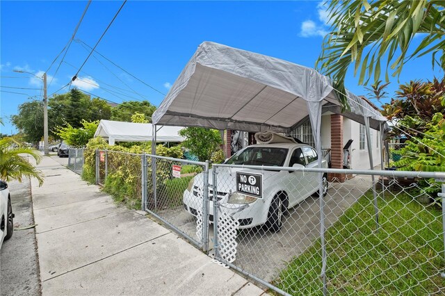 view of parking featuring a yard and a carport