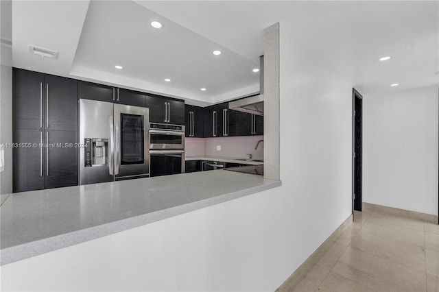 kitchen featuring light tile patterned floors, appliances with stainless steel finishes, and sink