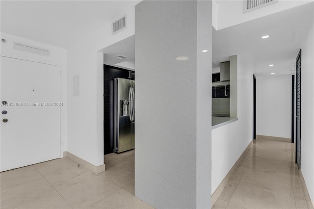 hall with light tile patterned floors