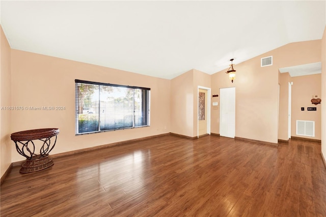 unfurnished room with wood-type flooring and lofted ceiling