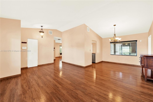 unfurnished living room with an inviting chandelier, lofted ceiling, and hardwood / wood-style flooring