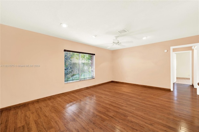 spare room featuring hardwood / wood-style floors and ceiling fan