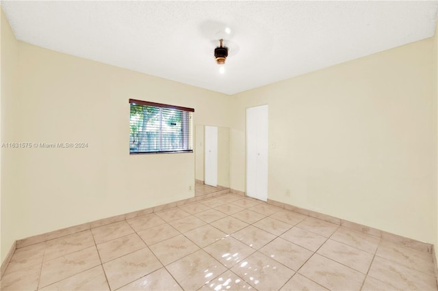 spare room with light tile patterned flooring