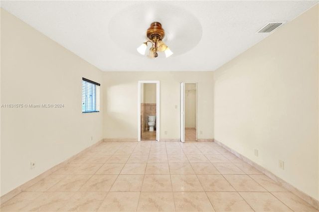 spare room with light tile patterned floors and ceiling fan